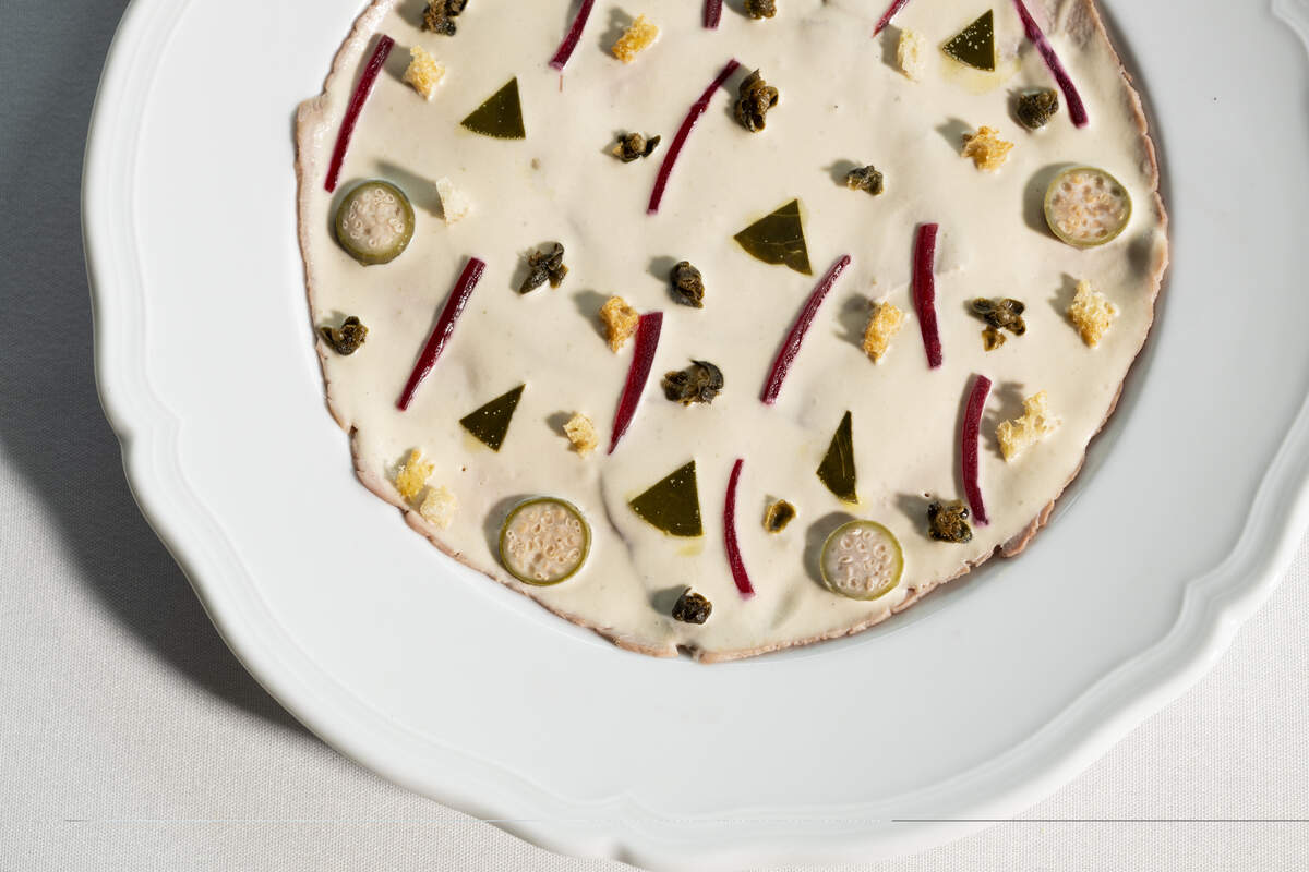 Vitello tonnato at Seia features paper-thin slices of veal decorated with a creamy tuna sauce, capers, pickled red onions and croutons.